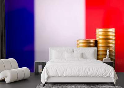 A stack of gold coins on the background of the flag of France. Country economy concept Wall mural