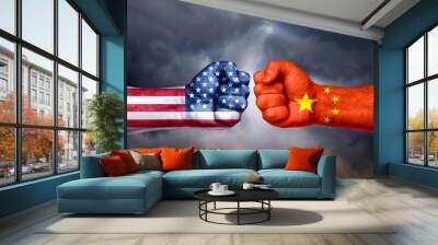 Flags of USA and China painted on two fists on sky background. United States of America versus China trade war disputes concept. Wall mural