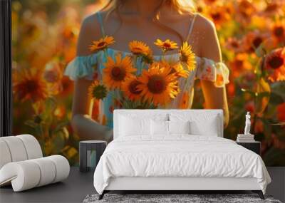 Close-up a young woman in summer dress holding vase with sunflowers and cosmos flowers in a summer garden at dusk Wall mural