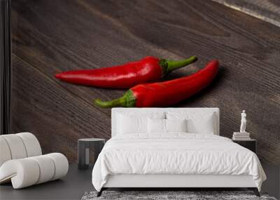 Two fresh chili peppers on a dark wood background, copyspace Wall mural