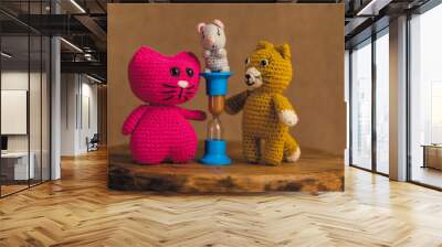 Amigurumi handmade dolls 2 cats and a mouse. The background is brown. Wall mural