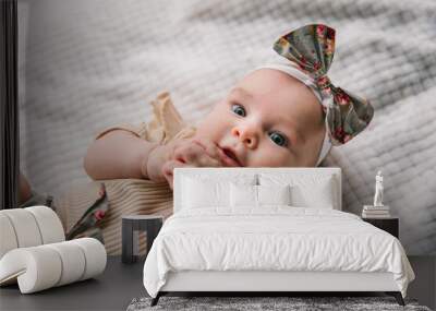 Three month old girl in a stylish suit with shorts and a hair band on a white background. Cute clothes for girls Wall mural