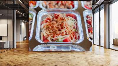 Foil container with chopped mushrooms, tomatoes and zucchini, sprinkled with mozzarella before roasting in the oven. Delivery menu during the fight against COVID-19 Wall mural