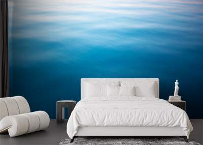 Blue water surface. Deep blue water background. Beautiful background, space for text. Wall mural