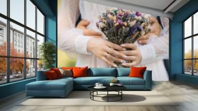 close-up of a bride with a bouquet of lavender and dry flowers Wall mural