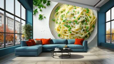 Delicious green and white tagliatelle pasta with peas and fresh herbs served in a rustic bowl Wall mural