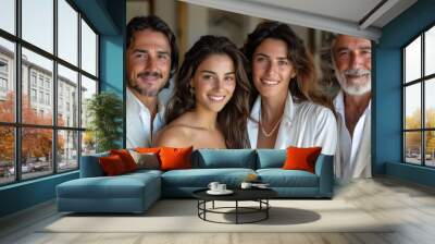 Family gathering in sunny living room with four smiling adults dressed in elegant attire Wall mural