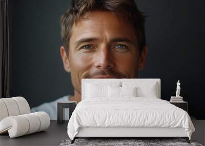 closeup portrait of caucasian softly smiling man is 35 years old wearing white T-shirt on grey color background Wall mural