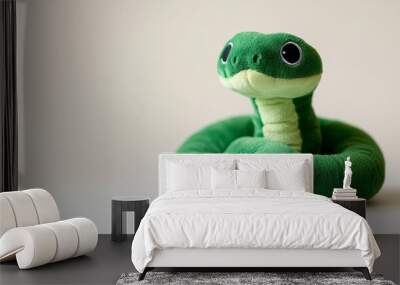 green plush snake on light background, symbol of 2025 year, soft toy Wall mural