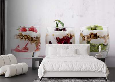 healthy dessert with whipped cottage cheese, granola, strawberries, cherries and kiwi on pink background Wall mural