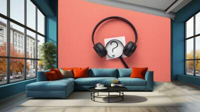 wireless headphones with magnifying glass and question mark on coral background Wall mural