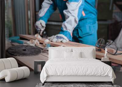 Woodworking tools on the table on the background of men at work in blur, selective focus, industrial background Wall mural