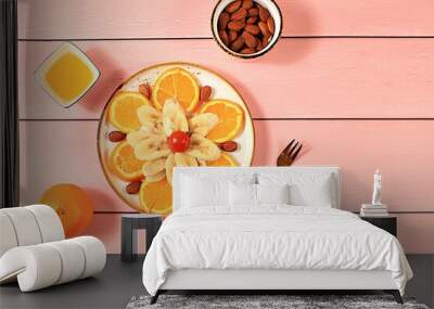 Healthy breakfast with ingredients, fun food for kids, food decoration ideas, healthy and natural food concept. Flower of bananas, oranges and nuts on a plate, Wall mural