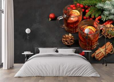 Strong alcoholic or non-alcoholic cocktail with cranberry, apple, orange and cinnamon, mulled wine, warming winter drink in the cold season, Christmas festive grog, winter composition, selective focus Wall mural