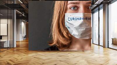 Close-up portrait of a girl in a mask of exhilaration with suspected coronavirus. New Coronavirus-2019-nCoV. Chinese outbreak of coronavirus. Wall mural