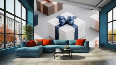 A set of three luxury gift boxes is beautifully arranged on an elegant table. The boxes, two in navy and one in white, feature dark blue ribbon bows, creating a sophisticated display. Wall mural