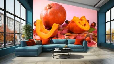 fresh whole pumpkin, pieces of pumpkin on a background of autumn leaves. Autumn background. Wall mural