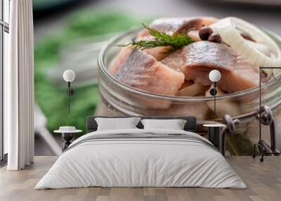 Marinated herring in a jar closeup. Wall mural