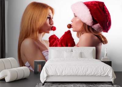 two beautiful girls with red hair cover their chest and licks chupachuupsy Wall mural