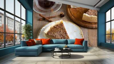 A piece of delicious pumpkin cheesecake with chocolate on a beautiful plate and a Cup of fragrant tea. Vertical photo Wall mural