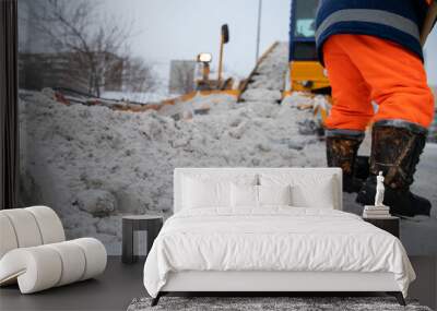 Communal services worker sweeps snow from road in winter, Cleaning city streets and roads during snowstorm. Moscow, Russia Wall mural