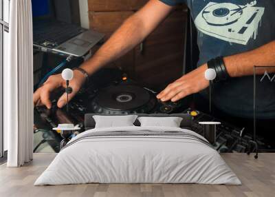 Dj mixes the track in the nightclub at party. In the background laser light show Wall mural