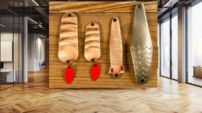 A set of lures for fishing on a wood background. Wall mural