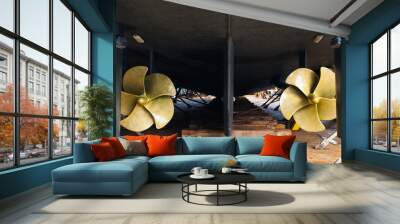 Aft with two propellers of the luxury motor yacht is dry docked on wooden blocks and supported by steel supports. Wall mural