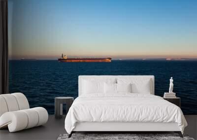 The bulk carrier is anchored at sea. Wall mural