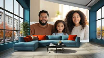 Happy family sitting together on couch, smiling indoors Wall mural