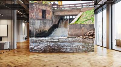 Old dam with abandoned power plant on a warm, spring day Wall mural