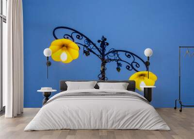 Two lamps on a pole in the early morning in winter.Yellow lanterns at night. Wall mural