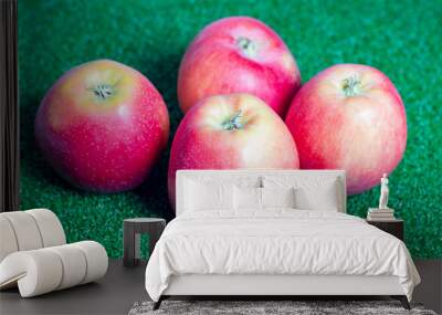 red apples isolated on green background Wall mural