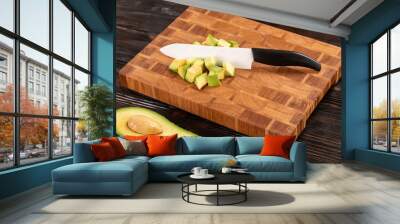 Avocado sliced on wooden cutting board Wall mural