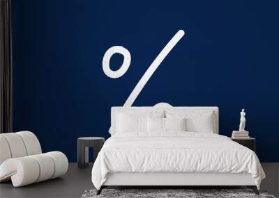 percent sign. man drawing a big percent symbol on a blue background Wall mural