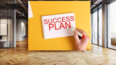 success plan. a man writes success plan in a notebook Wall mural