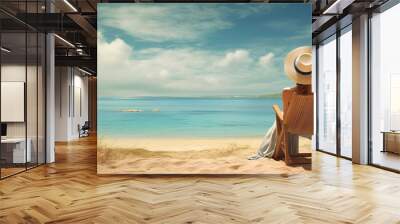 Beautiful Woman resting on the seashore. A girl in a hat sits on the seashore. Wall mural