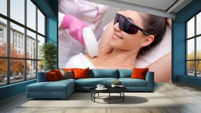 Hair removal for smooth skin, laser procedure in a beauty studio or clinic. A cosmetologist removes hair from a woman's armpits. Diode laser hair removal, body care. Wall mural