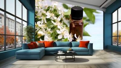 Aromatherapy oil bottle with the scent of spring cherry flowers Wall mural