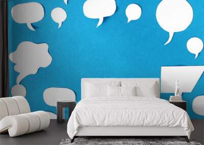 Many white clouds of thought type on a blue background with place for text. Wall mural