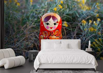 Matryoshka doll close-up on a background of wildflowers. Wall mural