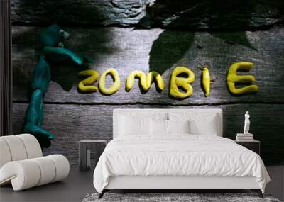 Zombie inscription on the wooden surface. Next to the figure of a zombie. Preparation for Halloween. Wall mural