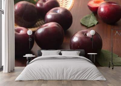 Plums on wooden background Wall mural