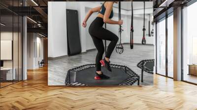 Fitness trainer jump at the modern gym Wall mural