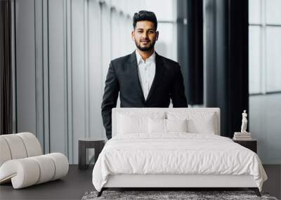 Handsome bearded Indian in a suit in the middle of the corridors of a modern office, modern building, manager, office worker Wall mural