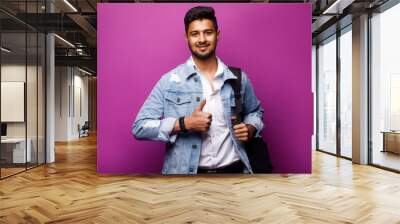 Portrait of handsome Indian guy, okay sign, standing on violet background, copy space at side. Wall mural