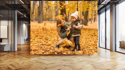 Young Mother with her little son in the autumn park have a fan. Yellow foliage, outdoor time with kids. Independent Happy Single Mother Wall mural