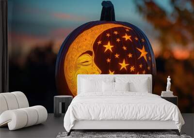 Carved pumpkin is glowing at sunset, showing the moon and stars for the halloween celebration Wall mural