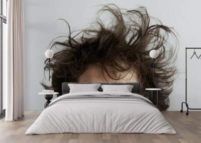 Close-up photo of a young man's messy bedhead, expressing a carefree attitude Wall mural