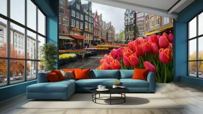 Colorful tulips are blooming in a flower market with typical dutch houses in the background Wall mural